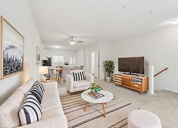 A living room with a white couch and a coffee table.