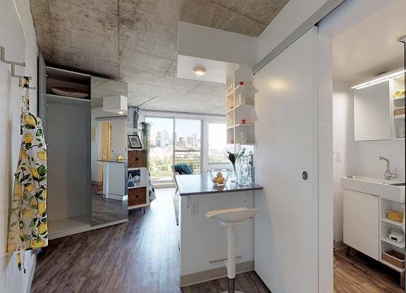 A bathroom with a white sink and a window.