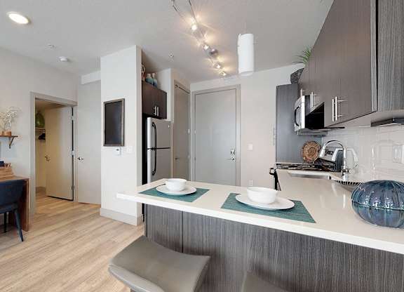 A modern kitchen with a dining table and chairs.