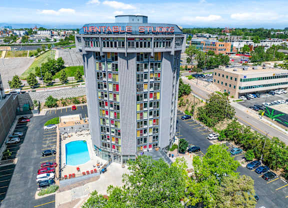 A tall building with a pool in front of it.