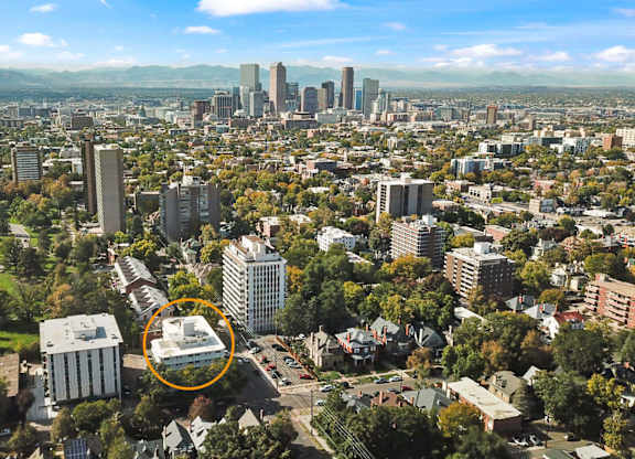 A cityscape with a large building circled in the middle.