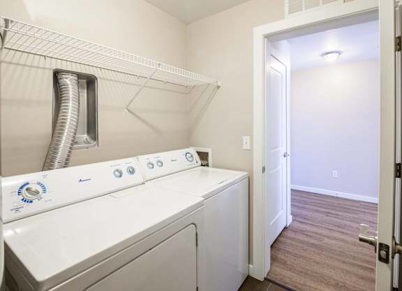 A white washer and dryer in a small laundry room.