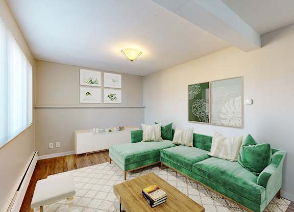 A living room with a green couch and a coffee table.