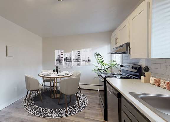 A kitchen with a table and chairs in the middle of the room.