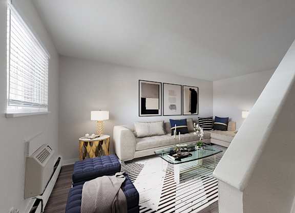 A living room with a staircase leading to the upper floor.