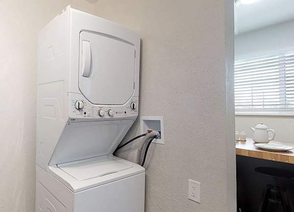 A white oven with a microwave above it is installed in a kitchen.