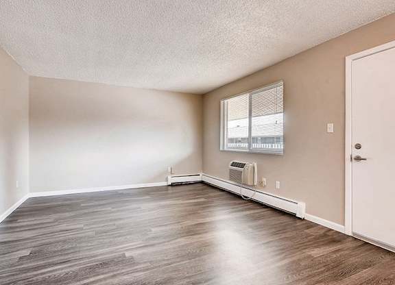 A room with a white door and a window with blinds.