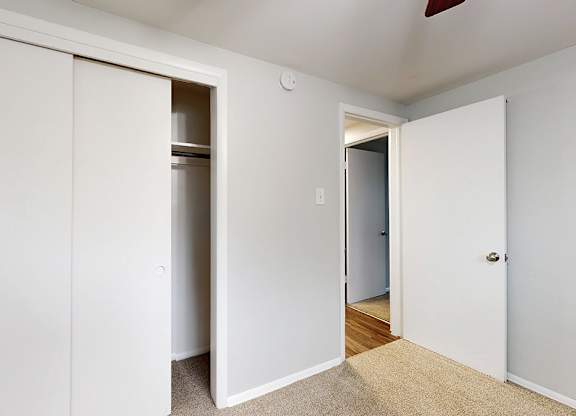 A white door is open to a hallway.