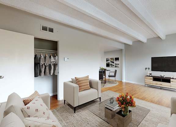 A living room with a sofa, armchair, and a coffee table.