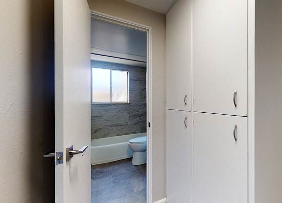 A bathroom with a tub, toilet and sink.