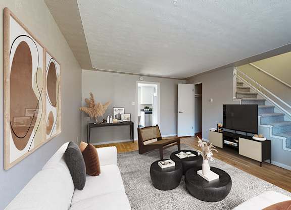 A living room with a white couch and a painting on the wall.