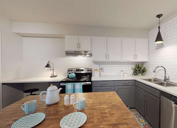 A kitchen with a wooden table and blue and white cups.