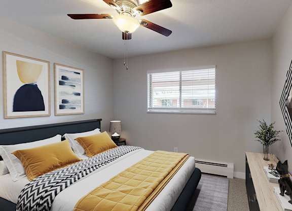 A bedroom with a bed, a mirror, and a ceiling fan.