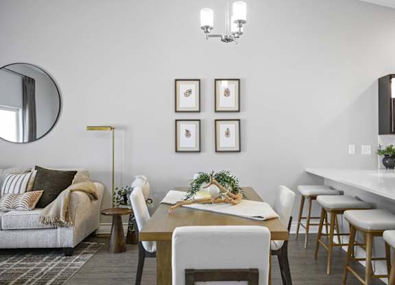 A modern dining room with a wooden table and chairs.