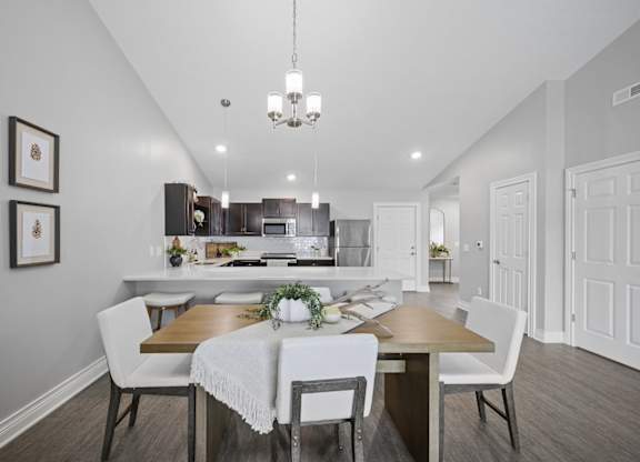 A dining room with a table set for four.
