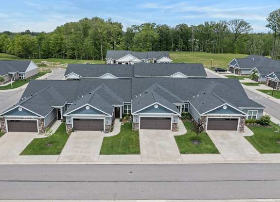 A row of houses with garages in front of them.