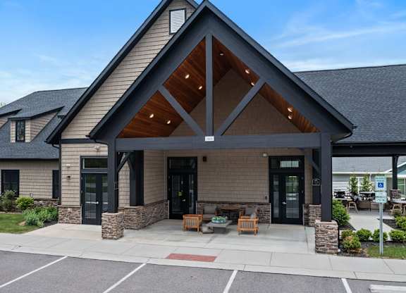 A modern building with a large front porch and a stone pillar.