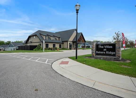 The Villas at Bakers Ridge is a large building with a parking lot in front.