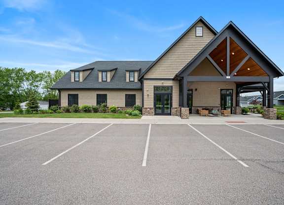 A large building with a parking lot in front of it.