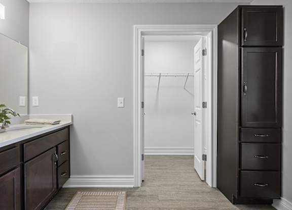 A bathroom with a white sink and a white door.