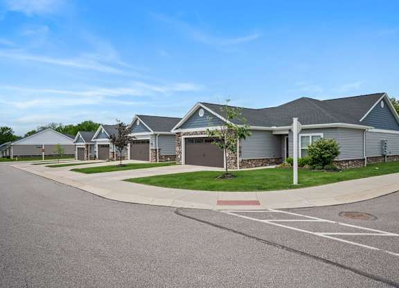 A row of houses with a clear blue sky above them.