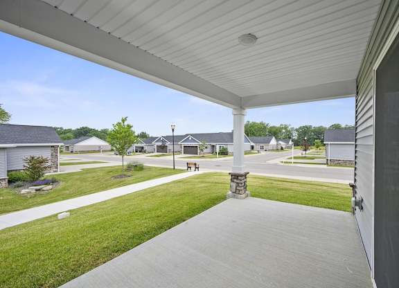 A white covered walkway leads to a house.