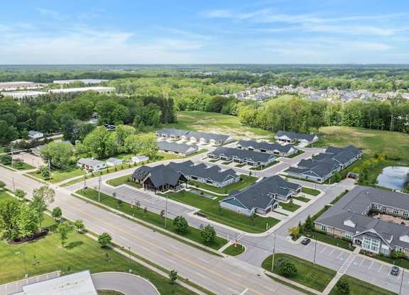 A bird's eye view of a suburban neighborhood with houses and a road.