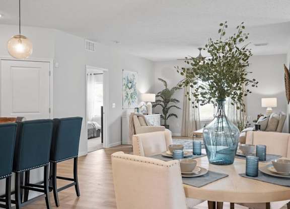 A dining room with a table set for six.