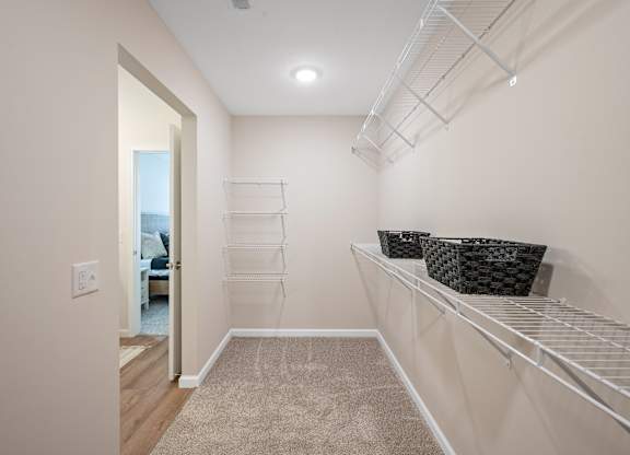 A walk-in closet with shelves and baskets.