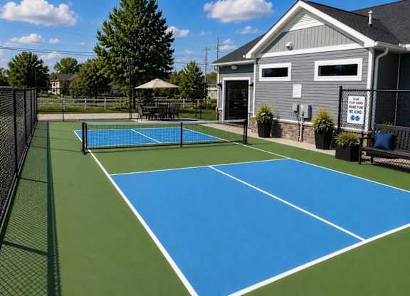 A tennis court with a blue surface and white lines.