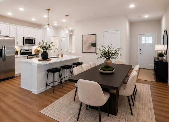 A modern kitchen with a dining table and chairs.