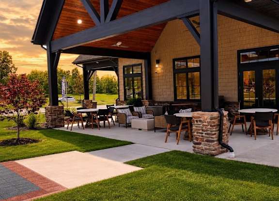 A patio area with a table and chairs is set up outside a house.