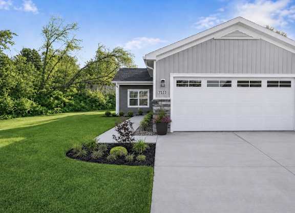 A two-car garage is attached to a house.