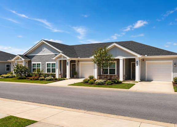 A house with a grey roof and white garage door.
