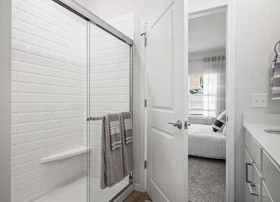 A bathroom with a white tub and a white door.