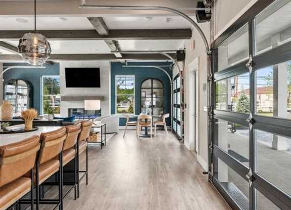 A modern interior with a long wooden table and chairs.