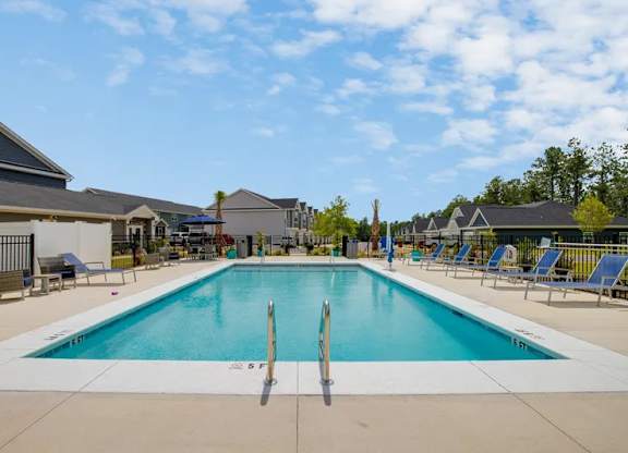A large swimming pool with a diving board in the middle of it.