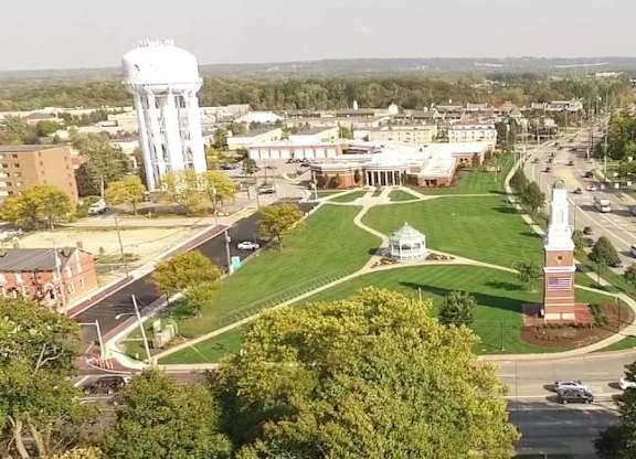 A town square with a water tower in the background.