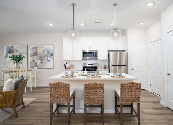 A modern kitchen with a dining table set for four.