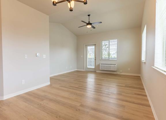 A room with a ceiling fan and a door leading to a balcony at Marcola Apartment Homes, Oregon, 97477
