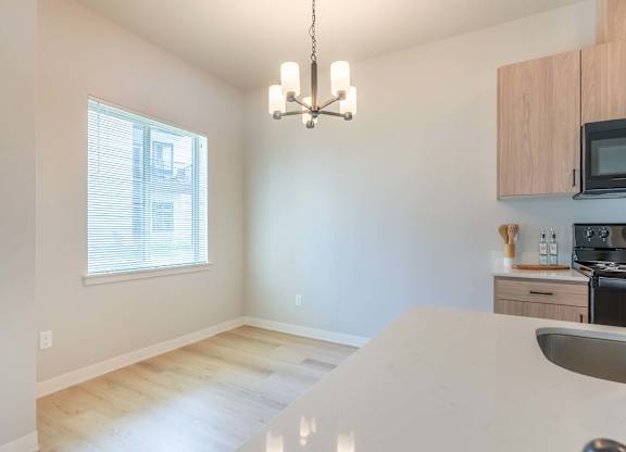 A kitchen with a white counter top and wooden cabinets at Marcola Apartment Homes, Forest Grove, 97477