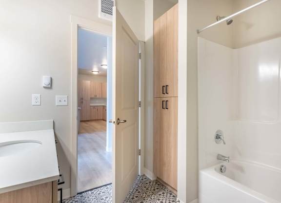 A bathroom with a white tub and a walk-in shower at Marcola Apartment Homes, Oregon