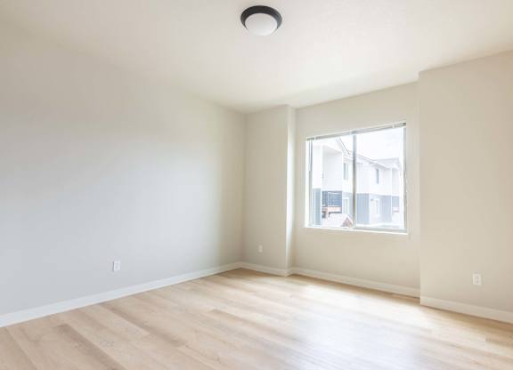 A room with a window and wooden flooring at Marcola Apartment Homes, Forest Grove, OR
