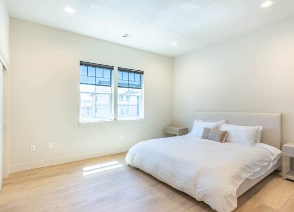 A bedroom with a large bed and a window at Westgate Apartment Homes, Oregon