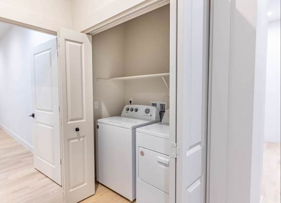 A white laundry room with a washer and dryer at Westgate Apartment Homes, Pendleton, 97801