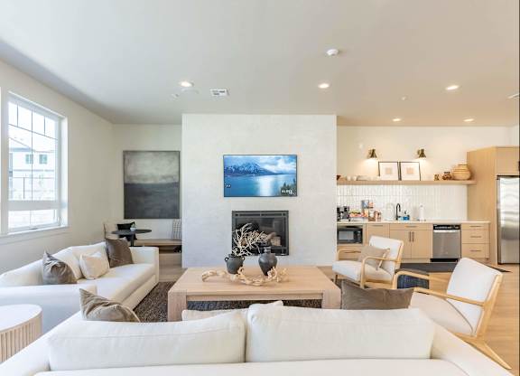 A modern living room with a fireplace and a painting on the wall at Westgate Apartment Homes, Pendleton, OR