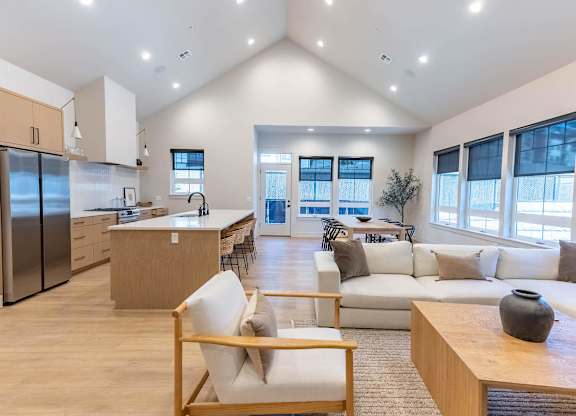 A modern kitchen with a refrigerator, sink, and cabinets at Westgate Apartment Homes, Oregon