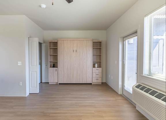 A room with a wooden floor and a window on the right side at Westgate Apartment Homes, Pendleton