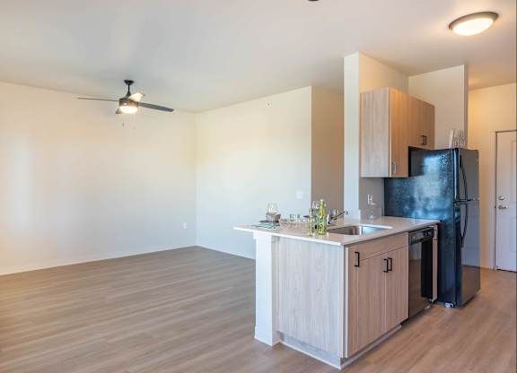 A kitchen with a black fridge and a wooden counter at Westgate Apartment Homes, Oregon