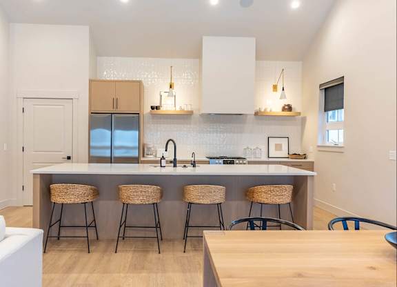 A kitchen with a white counter top and bar stools at Westgate Apartment Homes, Pendleton, OR, 97801